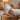 Grove barefoot sneaker in white, worn resting feet on a wood stump in a living room