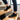 Grove barefoot sneaker in black, worn climbing wooden stairs showing the gum sole