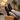 Terra barefoot trainer in black, worn with feet up on a wood block indoors, top down view