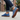 Stride barefoot sneaker for men in blue knit with gum sole, worn walking a sidewalk with tread visible