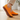 Stride barefoot sneaker in orange knit with brown sole, side view worn on a wood floor