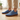 Stride barefoot sneaker in blue knit with gum sole, front view worn on a wood floor