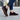 Stride barefoot sneaker in black knit with gum sole, worn walking a city street