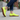 Stride barefoot sneaker in neon yellow knit with gum sole, worn standing on a sidewalk
