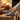 Stride barefoot sneaker in gray knit with brown sole, worn with feet up by a fireplace