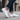 Flow barefoot slip on sneaker for men in white, worn walking a city sidewalk, three quarter view