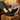 Flow barefoot slip on sneaker in black, worn with feet up on a wood block, side and sole view