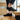 Flow barefoot slip on sneaker in black, worn stepping on wooden stairs, side view