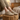 Meridian cushioned barefoot sneaker in sand worn with feet up on a wooden stump