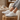 Meridian cushioned barefoot sneaker in white worn with feet up on a wooden stump