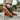 Sage barefoot sneaker in brown worn on a stone path, side view of the gum sole for men