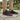 Sage barefoot sneaker in black tartan worn standing on a stone patio