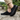 Sage barefoot sneaker in all black worn on stone, view of the black sole tread