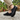 Sage barefoot sneaker in all black worn on a stone patio, side view