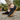 Ease barefoot slip on shoe in black, worn side view on cobblestone with gum sole