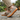 Loafers barefoot slip on shoe in beige worn on stone, side view of the gum sole