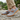 Loafers barefoot slip on shoe in grey worn on a stone path, side view of the gum sole