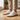 Pulse barefoot sneaker for men in white with gum sole, worn standing on a wood floor indoors, three quarter view
