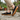 Loafers barefoot slip on shoe in black worn on a stone path, side view of the gum sole