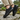 Breeze barefoot sneaker in black worn on rocks, view of the sole tread
