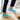 Wave barefoot sneaker in teal, worn on wooden stairs, side view with white sole