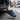 Wave barefoot sneaker in navy blue, worn stepping out of a car onto a city street