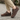 Summit barefoot hiking shoe in brown, side view worn on a wood deck