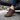 Summit barefoot hiking shoe in brown, close up worn stepping out of a car