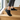 Summit barefoot hiking shoe in black, worn climbing wooden stairs