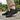 Summit barefoot hiking shoe in black, side view worn on a stone patio