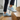 Summit barefoot hiking shoe in light blue, worn climbing wooden stairs