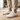 Terra barefoot trainer for men in white, worn standing on a wood floor indoors, three quarter view