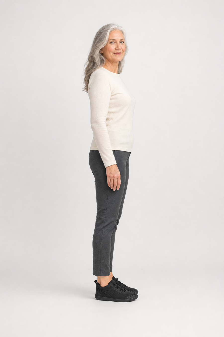 A woman standing in the Aspen shoes, side view showing her hips, knees, ankles and the ball of her foot