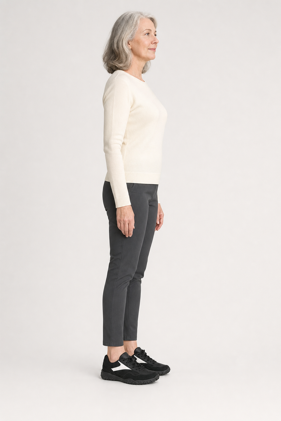 A woman standing in the Canyon shoes, side view showing her hips, knees, ankles and the ball of her foot