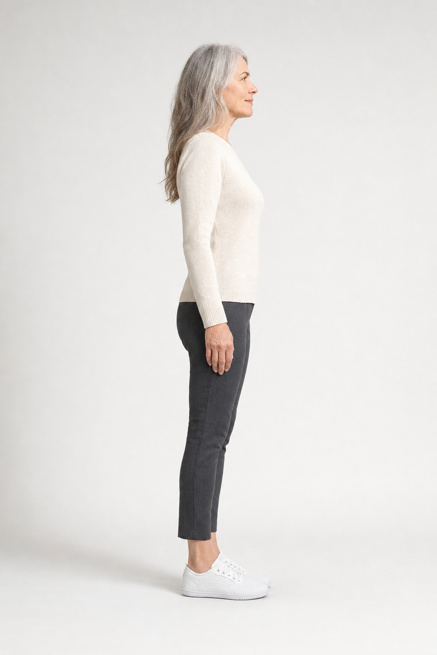 A woman standing in the Cove shoes, side view showing her hips, knees, ankles and the ball of her foot