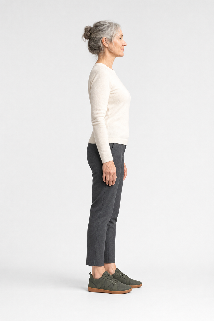 A woman standing in the Drift shoes, side view showing her hips, knees, ankles and the ball of her foot