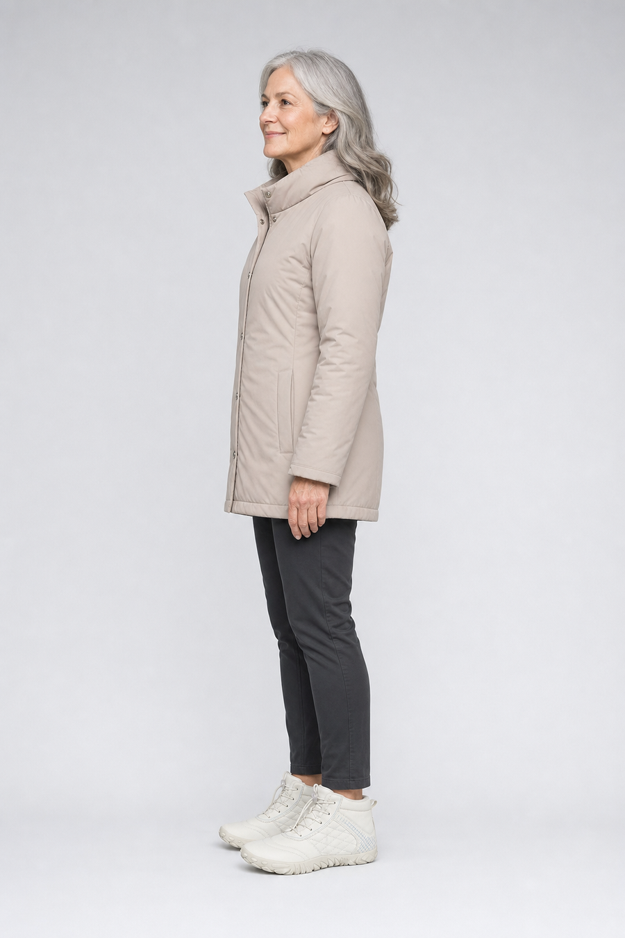 A woman standing in the FrostSpire boots, side view showing her hips, knees, ankles and the ball of her foot