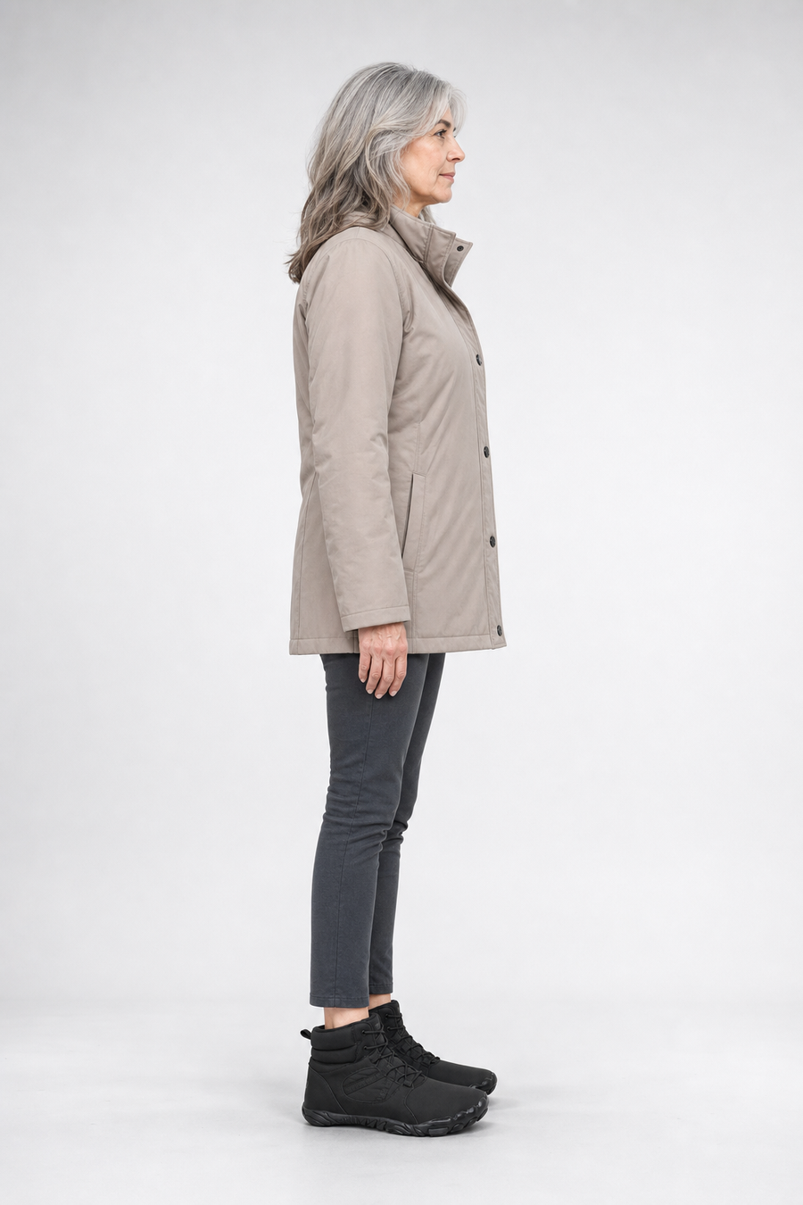 A woman standing in the FrostVenture boots, side view showing her hips, knees, ankles and the ball of her foot