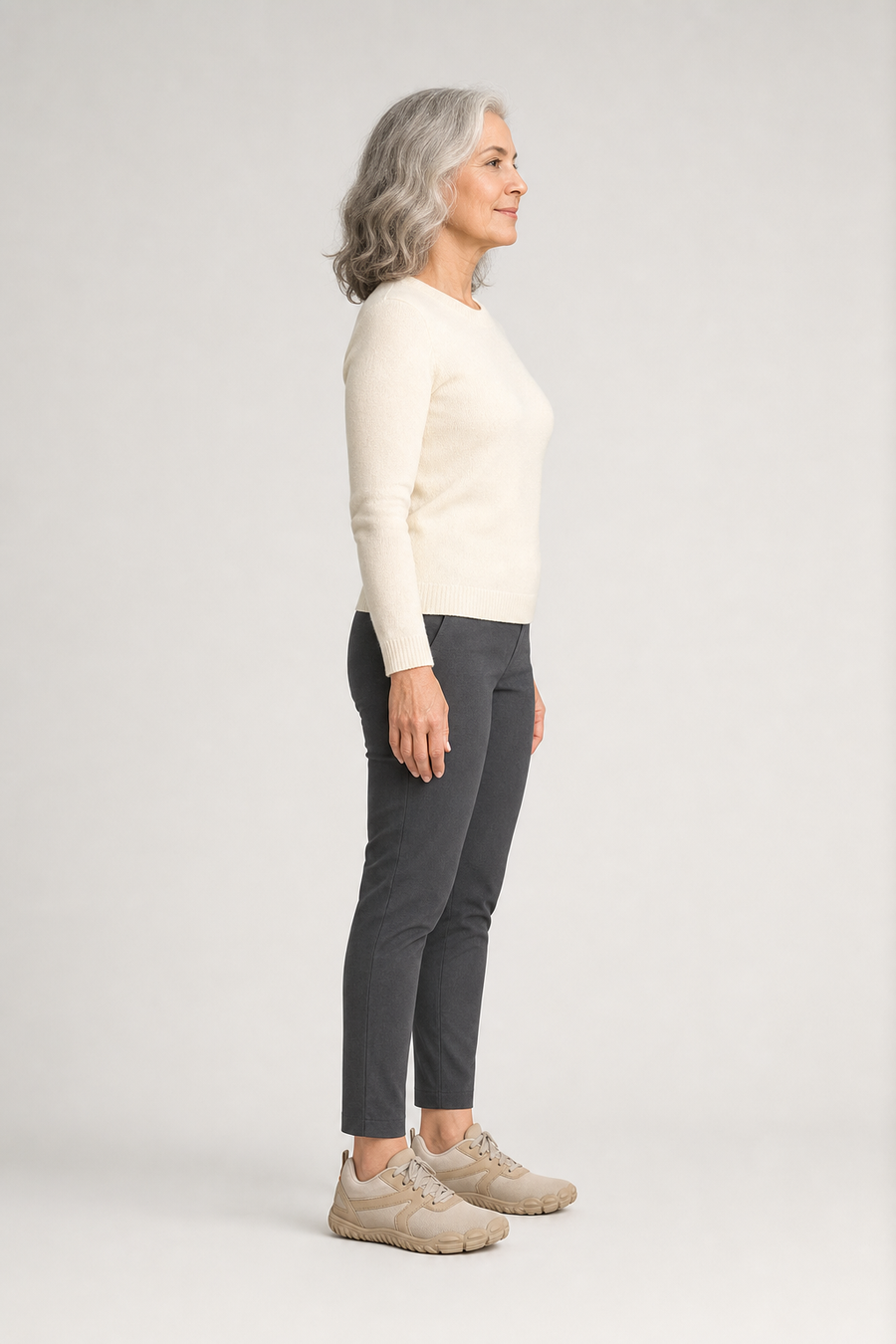 A woman standing in the Meridian shoes, side view showing her hips, knees, ankles and the ball of her foot
