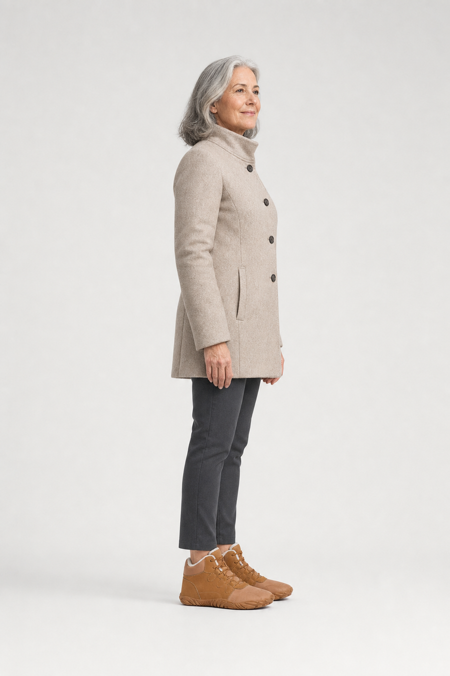 A woman standing in the NorthBound boots, side view showing her hips, knees, ankles and the ball of her foot
