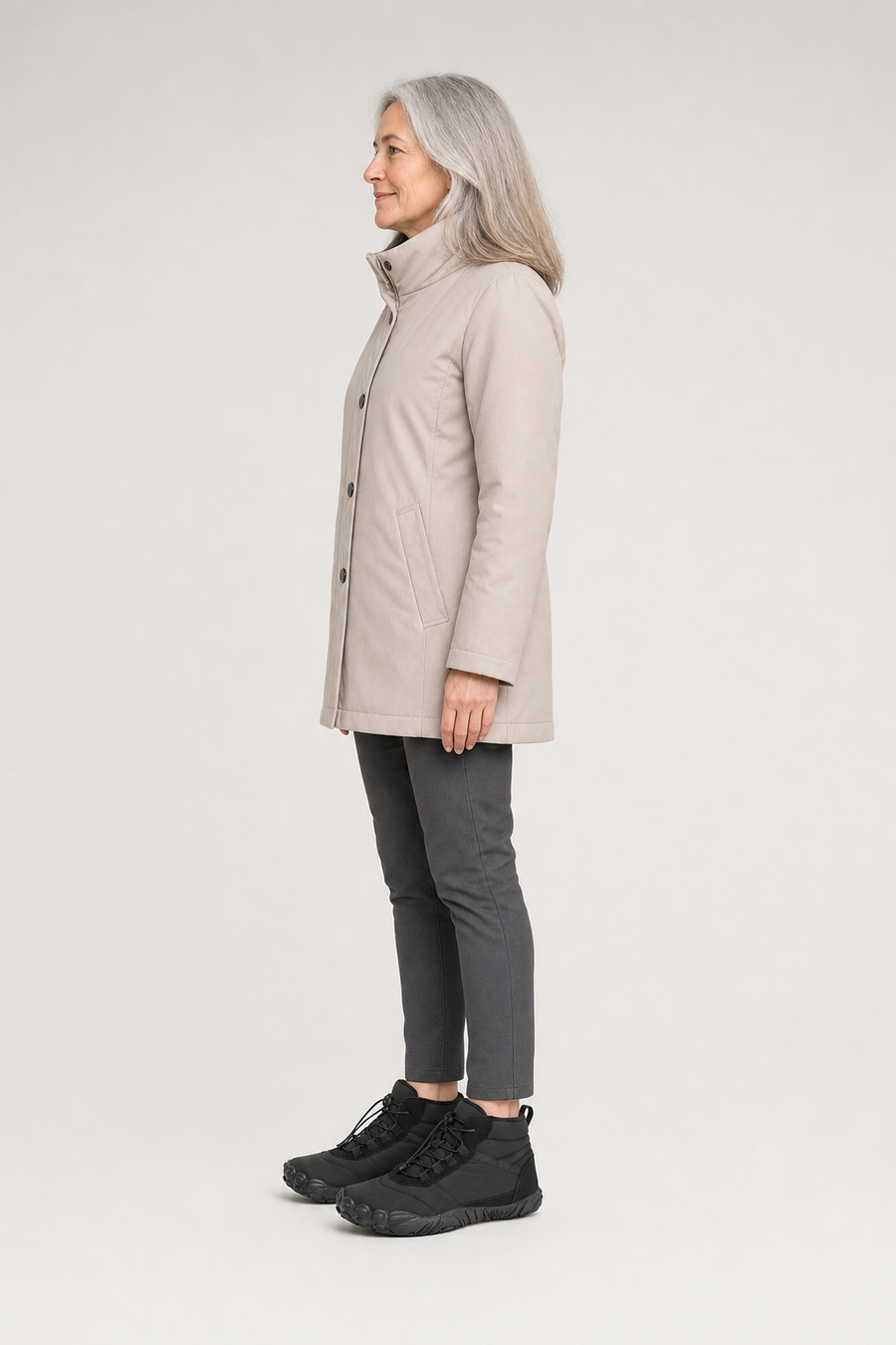 A woman standing in the Polar boots, side view showing her hips, knees, ankles and the ball of her foot