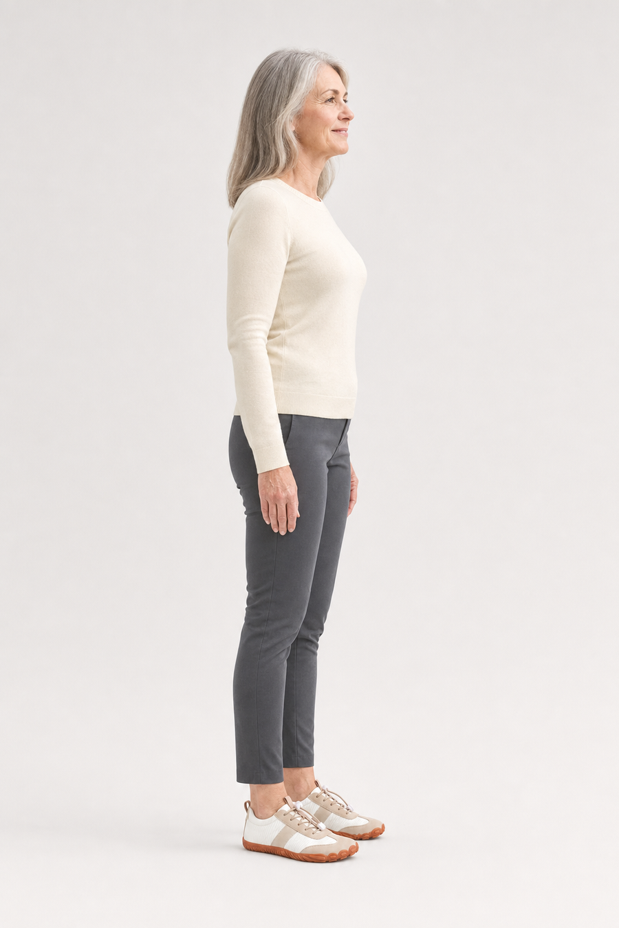 A woman standing in the Prairie shoes, side view showing her hips, knees, ankles and the ball of her foot