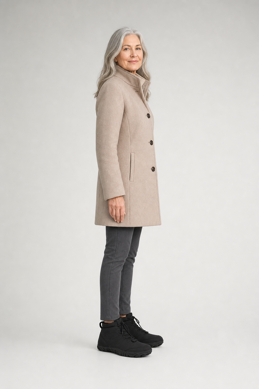 A woman standing in the Tundra boots, side view showing her hips, knees, ankles and the ball of her foot