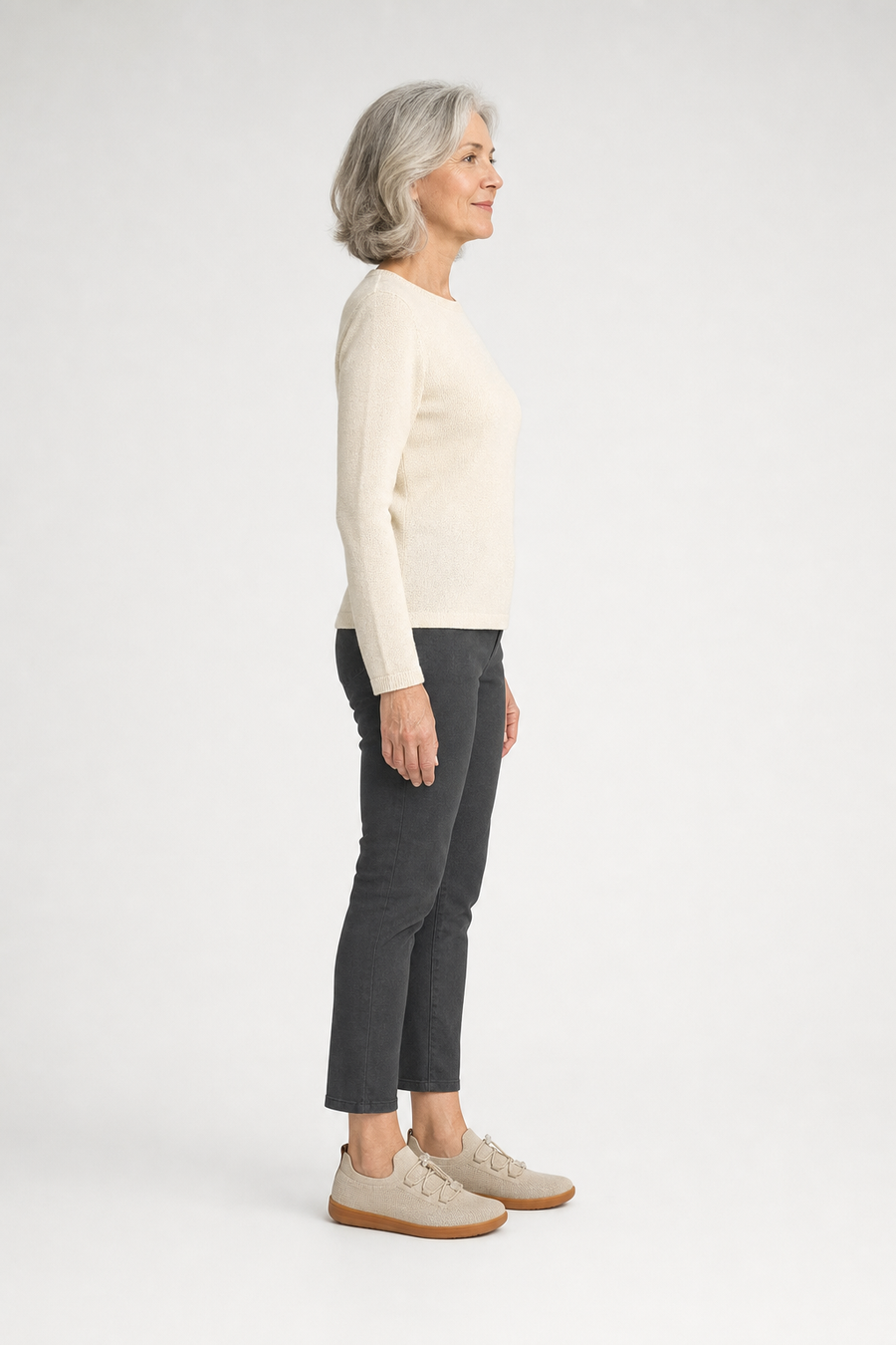 A woman standing in the Willow shoes, side view showing her hips, knees, ankles and the ball of her foot