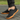 Ease barefoot slip on shoe for men in black, worn side view walking on stone paving