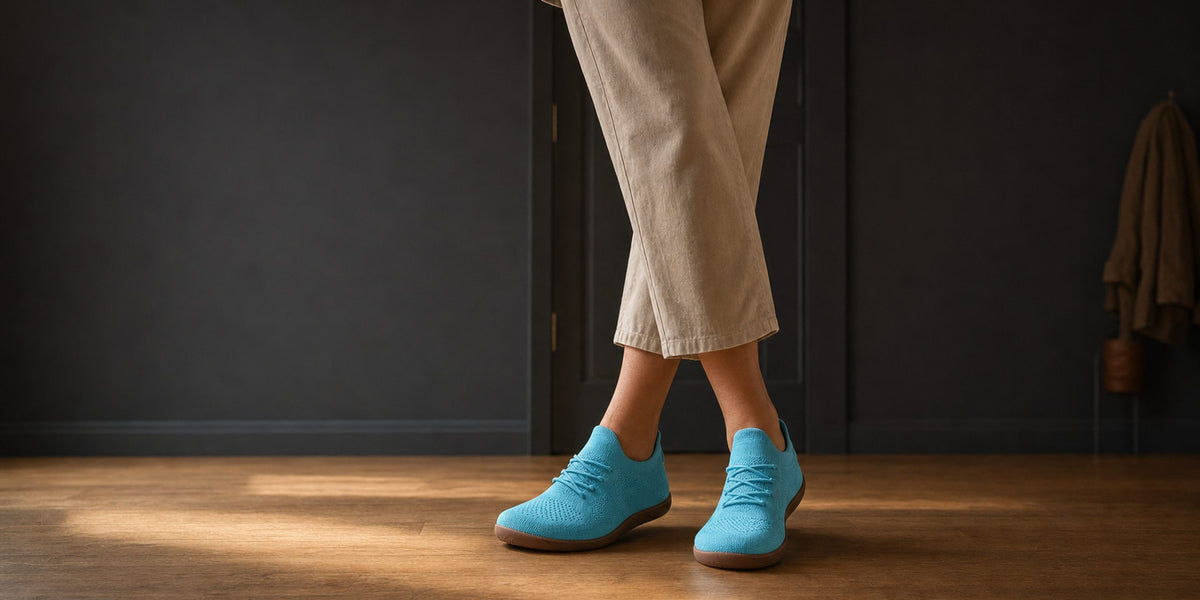 Woman by the front door wearing the Stride barefoot sneakers